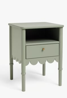 a small green table with a drawer on it