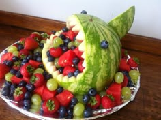 a watermelon shark made out of fruits and vegetables