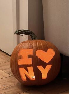 a carved pumpkin with the word hy written on it's face and in the shape of a heart