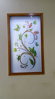 a painting on the wall with flowers and leaves painted on it's glass frame