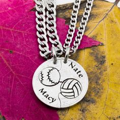 a silver necklace with a volleyball ball on it and the words mate may written in black ink