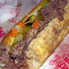 a close up of a sandwich with meat and vegetables