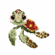 a cross stitched teddy bear holding a bouquet of flowers