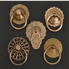 four different types of door knobs on a black surface