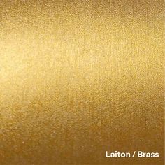 a gold metallic background with the words laton / brass on it's side