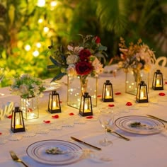 the table is set with candles, plates and place settings for an elegant wedding reception