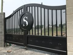 a black gate with the letter s on it