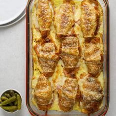 a casserole dish with meatballs and green beans on the side next to it