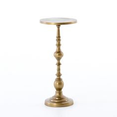 a gold metal table with a glass top