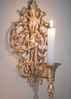 Make a Statement - Create an alluring ambiance with these stunning gothic gold candle sconces. Their rich metallic finish and dark, dramatic style will illuminate any room. With their bold vintage-inspired design, these sconces add intrigue and allure to any space. The antique gold finish and gothic accents create a luxe, moody vibe perfect for living rooms, bedrooms, and more. Flickering candlelight casts a warm, romantic glow and highlights the sconces' ornate details. Place them on either sid Rococo Candle Sconces, Gold Accent Room, Dark Academia Diy, Gold Candle Sconces, Dramatic Decor, Cross Candle, Gothic Candle, Gold Sconces, Cross Candles