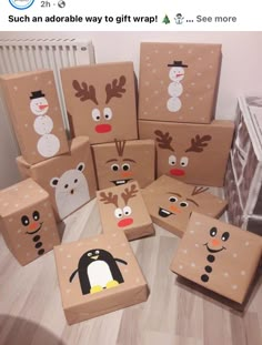 several cardboard boxes decorated with christmas characters and snowman faces on them, sitting on the floor in front of a radiator