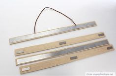 three pieces of wood with metal strips attached to them