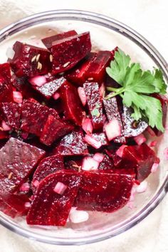 beets and onions in a glass bowl with parsley on the side for garnish