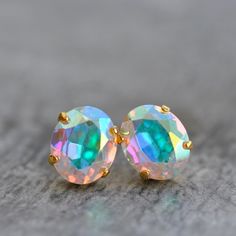 our Swarovski Crystal Oval Cushion Cut Stud/Post Earrings in very rare vintage Aurora borealis pastel rainbow. Our lovely crystal oval studs are the perfect everyday earring that can be dressed up or down. The rare oval shape gives this classic stud a little extra edge - these are a great gift, or to keep for yourself of course! D E T A I L S: * Made with Swarovski crystals in very rare vintage aurora borealis pastel rainbow. * Length: Earrings are 12mmL or 1/2"L. * Earrings are stud post and co Multicolor Round Crystal Earrings For Gift, Round Crystal Stud Earrings, Nickel-free Iridescent Round Earrings, Luxury Rainbow Gemstone Earrings, Iridescent Opal Cabochon Jewelry, Crystal Stud Earrings, Earrings Vintage, Everyday Earrings, Pastel Rainbow