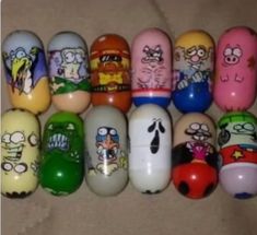 a bunch of cartoon characters painted on some kind of egg shell shells, all in different colors and sizes