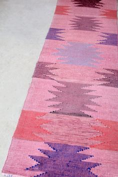 a pink and purple rug on the floor