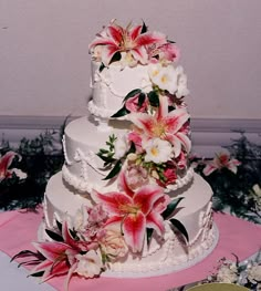 a wedding cake with pink and white flowers on it