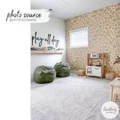 a living room with giraffe print wallpaper and green bean bags on the floor