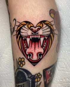 a close up of a tattoo on a person's leg with a tiger face