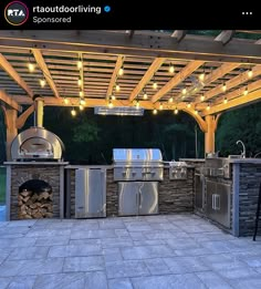 an outdoor kitchen with grills and lights