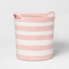 a pink and white striped basket with handles on the bottom, sitting against a white background