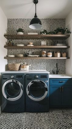 a washer and dryer in a laundry room with shelves above the washer