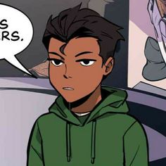 a boy in a green hoodie looking at the camera with an angry look on his face