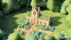 an aerial view of a castle in the middle of trees and bushes with blue flowers