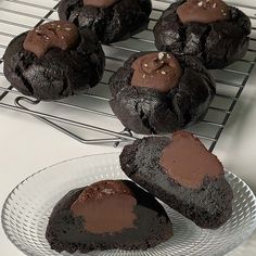 several chocolate cookies are on a cooling rack