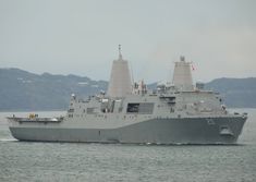 a large gray ship in the water