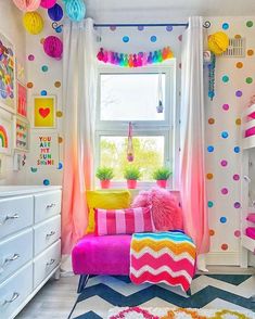 a brightly colored room with polka dot curtains