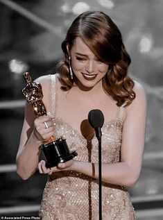 the actress is holding an award in her hand