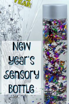 a bottle filled with lots of confetti next to a new year's message