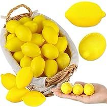 a basket filled with yellow lemons next to a person's hand and other items