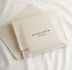 two white napkins with the words pandasew on them