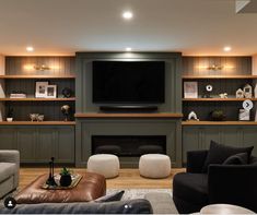 a living room filled with furniture and a flat screen tv mounted on the wall above a fireplace