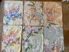 six different flowered napkins laid out on a table