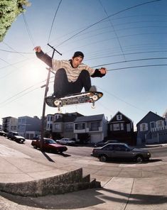 a man flying through the air while riding a skateboard on top of a metal pole