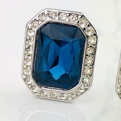 "Vintage 90s Kenneth Jay Lane KJL QVC Blue Sapphire Glass Diamanté Pave Crystal Faceted Emerald Cut Earrings SIGNED. Beautiful Vintage 90s Kenneth Jay Lane QVC Blue Sapphire Glass Crystal Clip On Earrings. Gorgeous Classic Design. Has A Large Faceted Blue Sapphire Glass Emerald Cut Stone Surrounded By A Border Of Diamanté Pave Clear Crystals. The Exquisite Blue Glass Stone Pairs Beautifully With The Sparkling Clear Crystals. Made Of Silver Or Rhodium Plate With Classic Clip On Style Back. A Glam Emerald Cut Earrings, Cut Earrings, Clear Crystals, Kenneth Jay Lane, Glass Crystal, Emerald Cut, Blue Glass, Clear Crystal, Rhodium Plated