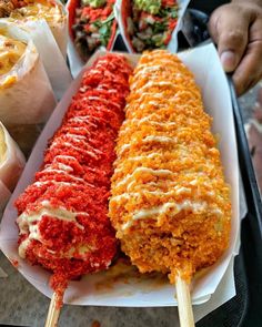 three different types of food on sticks with dipping sauces and condiments in the background