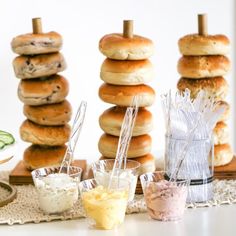 a table topped with lots of donuts covered in frosting next to other food items