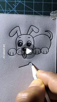 someone is drawing a cartoon dog on paper with a marker and pencils in their hands