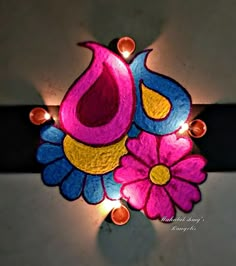 an artistically decorated diya with candles