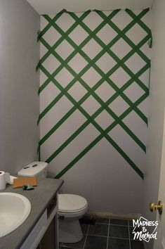 a bathroom with green lines painted on the wall