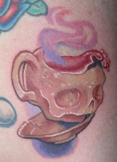 this is a drawing of a tea cup and saucer on someone's stomach