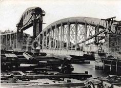 an old black and white photo of a bridge being built