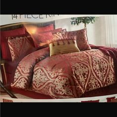 a red and gold comforter set with pillows