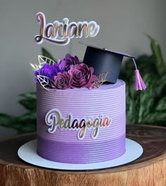 there is a purple cake with flowers on it and the word lariane written in cursive writing