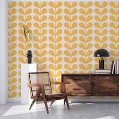 two chairs and a table in front of a wall with yellow leaves on it, against a white background