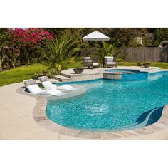 an empty swimming pool with lounge chairs around it